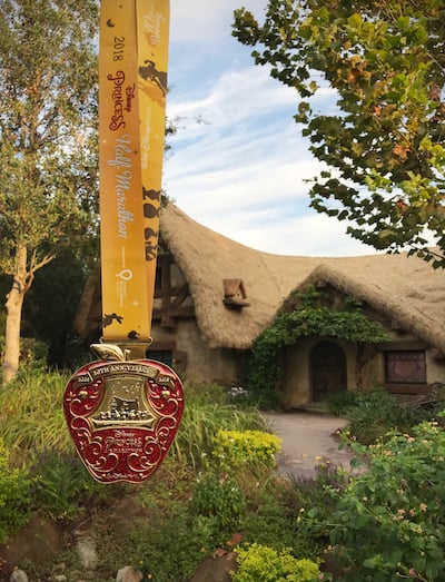 The 2018 Princess Half Marathon medal is a nod to Snow White and the Seven Dwarfs.